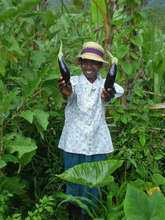 Joline proudly shows eggplant grown in Mena, Haiti