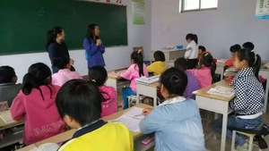 GlobalGiving staff in class with students