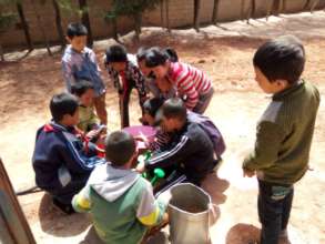 Children distributing water with buckets