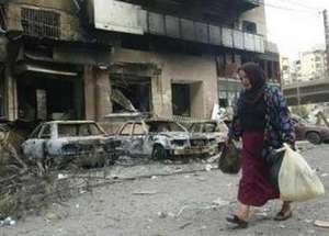 Woman with her Belongings Flees Southern Beirut