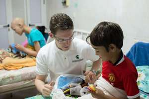 MSU medical student plays with child in oncology