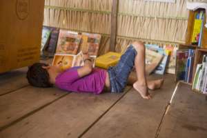 Boy enjoying a good reading at the library