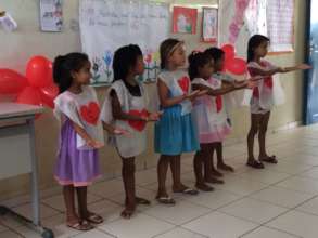 Children presenting their work to the mothers