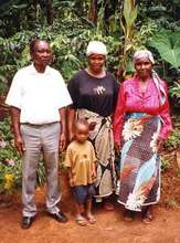 A Tanzanian farmer poses with his family
