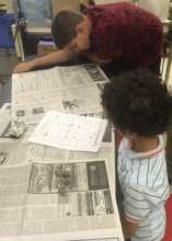 Kevin helps Ahmad examine bones from a pellet