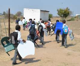 Carrying Tutudesks and chairs to school