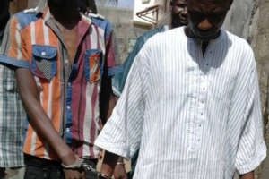 Arrested trafficker Aziz Sall being taken away