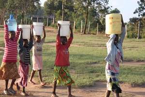 Our children carrying water from the stream