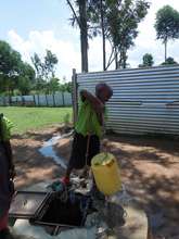 Boy fetching water from the old bore hole