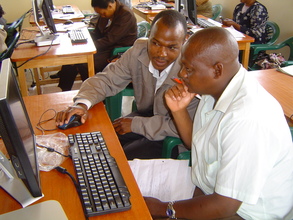 Teachers learning computer skills at the LRC