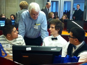 JA volunteer Lou Othote works with a student team.