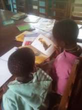 Reading in Kitengesa library, Uganda