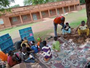 Schoolchildren read books from mobile library