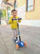 Hank riding on a kickboard at the children's home