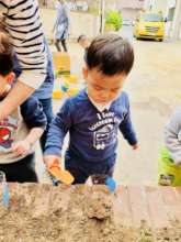 Jay is developing curiosity as he plants flowers.