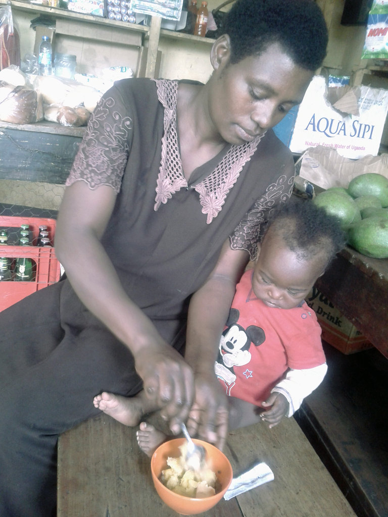 Sarah feeds her child Ekitobeero in rural Uganda