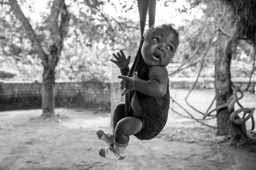 A healthy and happy baby being weighed at Shanti.