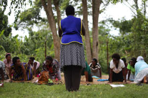 Flora teaching a prenatal yoga class to mothers.