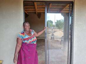 Stephine standing infront of here new home!
