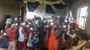 Hilonga with children with their solar lanterns