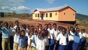 Gongali Children beside their new school