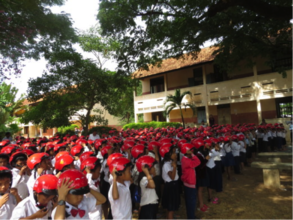Students learn how to wear their helmets properly.
