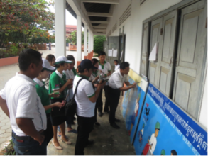 Volunteers paint a mural at a school in Siem Reap.