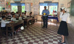 Students learn how to properly put on a helmet.