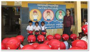Students demonstrate how to wear helmets correctly