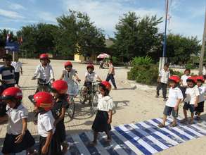 Students practice walking across the street safely