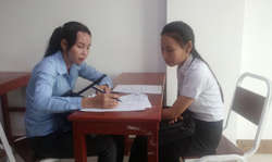 A university student in Cambodia takes a survey.