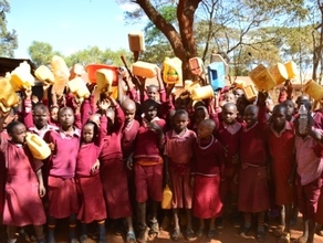 School kids displaying empty containers of water