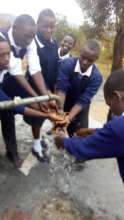 Students enjoying the flowing water.