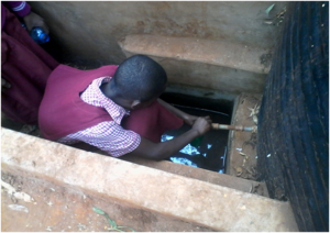 A pupil drawing drinking water from water tank