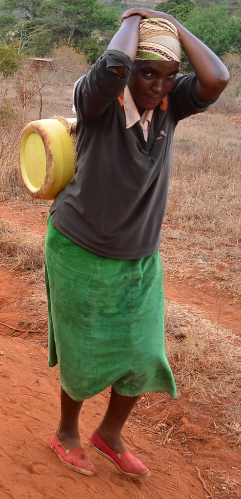 Woman Carrying water on her back