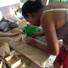 Lalaina covers a woven, water hyacinth mat