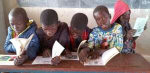 Reading books provided by mobile library