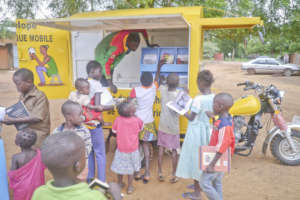Schoolchildren gather around the mobile library
