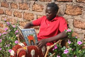 Girl Reading Outside Dimikuy Library