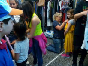 Fixing the new dress on the size of the young lady