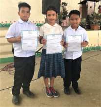 Students displaying their awards