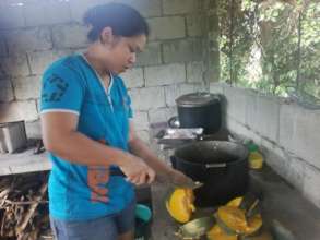 Moms cooking lunch for storm survivors at school