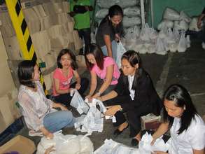 Volunteers pack food for AAI-IPI typhoon relief
