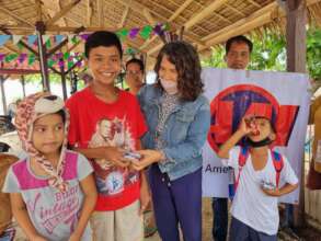 Smiles as children receive supplies