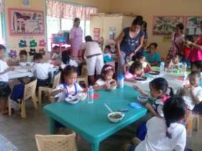 Moms and Dads serve school lunch