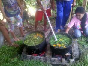 Moms cooking colorful fresh veggie soup