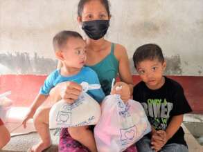 Family receiving hygiene supplies