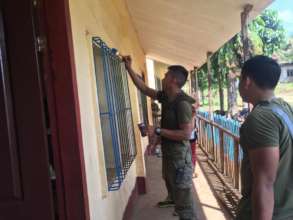 Soldiers help the community by helping to paint