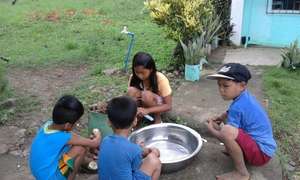 school children help Moms prepare garden lunch