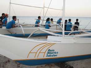 AAI youth volunteers carrying new boats to sea